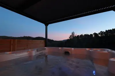 a hot tub with a view of the mountains at L'Amoré - Cabane en A avec spa privatif in Durban-Corbières