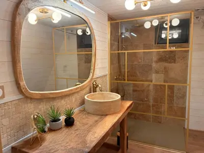 a bathroom with a sink and a mirror at L'Amoré - Cabane en A avec spa privatif in Durban-Corbières