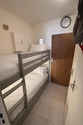 a room with two bunk beds and a clock on the wall at NOUVEAU 