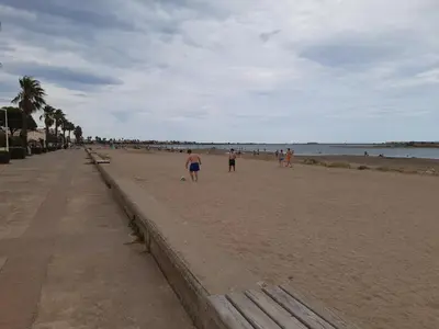 a group of people walking on the beach at NOUVEAU 