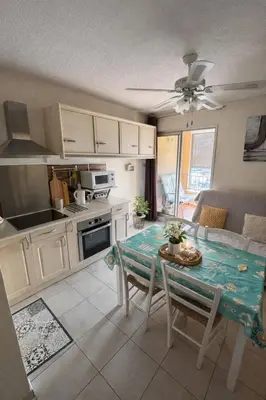a kitchen and living room with a table and chairs at NOUVEAU 