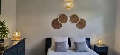 a bedroom with a bed with two hats on the wall at Domaine De L'aube Des Temps in Raissac-dʼAude