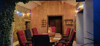 a dining room with a wooden table and chairs at Domaine De L'aube Des Temps in Raissac-dʼAude
