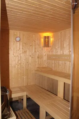 a wooden sauna with two benches in a room at Domaine De L'aube Des Temps in Raissac-dʼAude