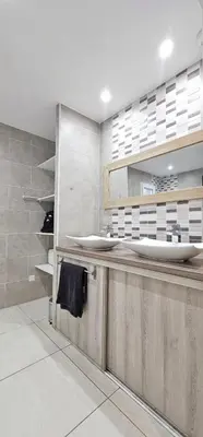 a bathroom with a counter with two sinks at Maison vacances avec piscine Pennautier in Pennautier