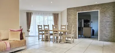 a living room with a table and chairs and a couch at Maison vacances avec piscine Pennautier in Pennautier
