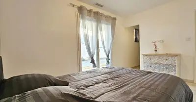a bedroom with a large bed and a window at Maison vacances avec piscine Pennautier in Pennautier