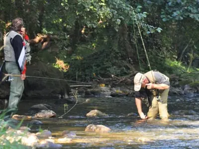 two men standing in a stream with a fishing rod at Chalet familial 5 pers avec terrasse à Axat - API-1-52-1152 in Axat