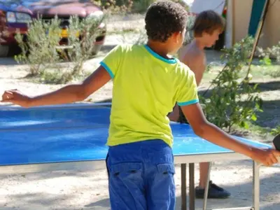 a young boy is playing with a frisbee at Chalet familial 5 pers avec terrasse à Axat - API-1-52-1152 in Axat