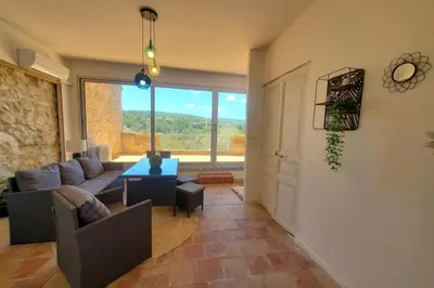 a living room with a couch and a table at Via Domitia Spacieuse maison 5 chambres in Portel-des-Corbières