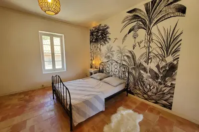 a bedroom with a bed with a mural on the wall at Via Domitia Spacieuse maison 5 chambres in Portel-des-Corbières