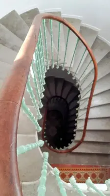 a spiral stair case with a spiral staircase at Via Domitia Spacieuse maison 5 chambres in Portel-des-Corbières