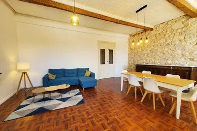 a living room with a blue couch and a table at Via Domitia Spacieuse maison 5 chambres in Portel-des-Corbières