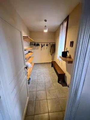 a hallway of a room with a door and a bench at Gîte La Bastide Saint-Roc Haute Vallée de l'Aude in Antugnac
