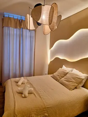 a bedroom with a bed with two towels on it at Le Damier in Castres