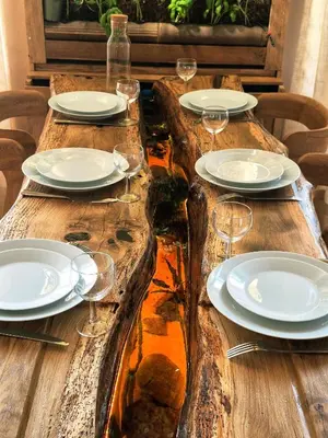a wooden table with plates and wine glasses on it at Le Damier in Castres