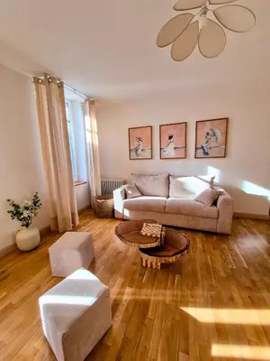 a living room with a couch and a table at Le Damier in Castres