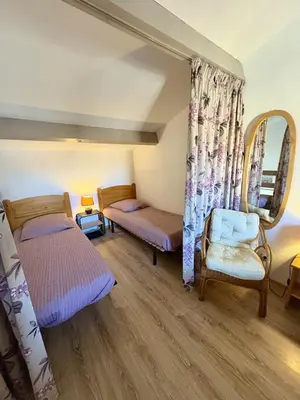 a bedroom with two beds and a mirror at Pavillon familial à deux pas de la plage in Gruissan