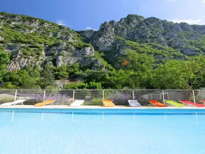 a group of chairs sitting next to a swimming pool at Bungalow toilé avec terrasse jusqu'à 5 personnes - API-1-52-1480 in Axat