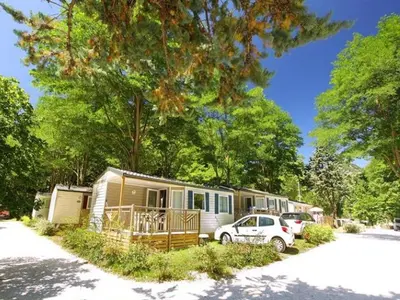 an rv is parked in a parking lot at Bungalow toilé avec terrasse jusqu'à 5 personnes - API-1-52-1480 in Axat