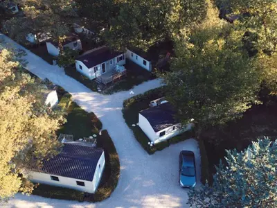 an aerial view of a house with a parking lot at Bungalow toilé avec terrasse jusqu'à 5 personnes - API-1-52-1480 in Axat