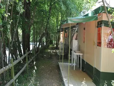 a house with a porch with a fence and trees at Bungalow toilé avec terrasse jusqu'à 5 personnes - API-1-52-1480 in Axat