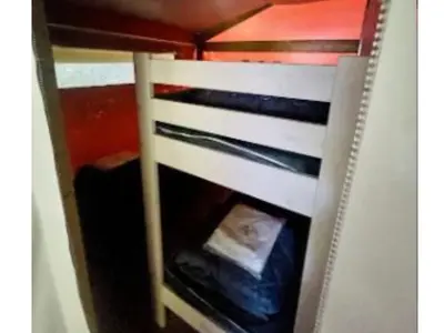 a bunk bed with a ladder in a room at Lodge 22m² avec Terrasse - Pour 5 Personnes - API-1-52-1500 in Camon