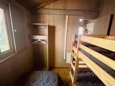 a small room with a bunk bed and a window at Cabane sur pilotis avec terrasse au calme - API-1-52-1502 in Camon