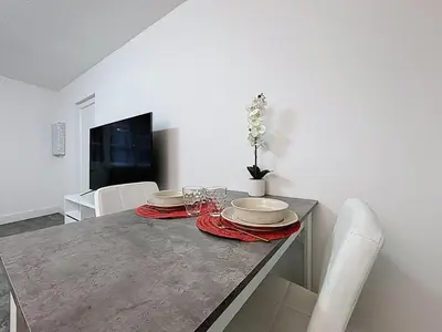 a dining room table with plates and glasses on it at Le Flatters - studio en hyper centre - Proche des Halles in Narbonne