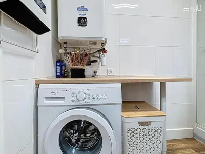 a kitchen with a washing machine and a counter at Le Flatters - studio en hyper centre - Proche des Halles in Narbonne