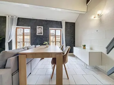 a living room with a table and a couch at Le Vicomte - Appartement en Duplex - Centre ville in Narbonne