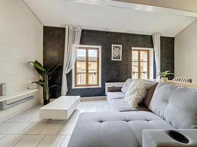 a living room with a couch and a table at Le Vicomte - Appartement en Duplex - Centre ville in Narbonne
