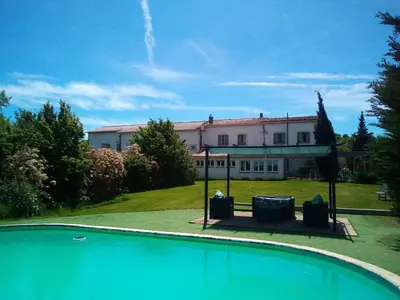 a house with a swimming pool in front of a building at Holiday Home Haus für 6 Personen und 8 Kinder in Villautou by Interhome in Villautou