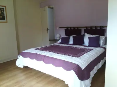 a bedroom with a large bed with purple pillows at Holiday Home Haus für 6 Personen und 8 Kinder in Villautou by Interhome in Villautou