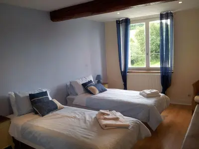 two beds in a room with a window at Holiday Home Haus für 6 Personen und 8 Kinder in Villautou by Interhome in Villautou