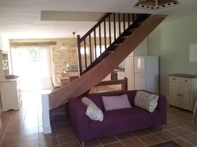 a living room with a purple couch and a staircase at Holiday Home Schönes Ferienhaus mit Pool in Villautou by Interhome in Villautou