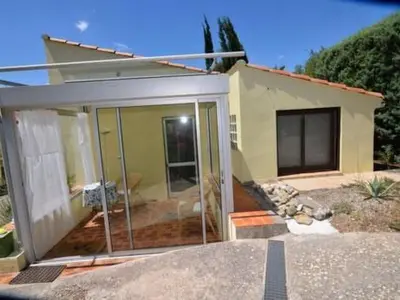 a house with sliding glass doors in front of it at Apartment Die kleine Zikade by Interhome in Cesseras
