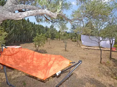 an orange tarp hanging from a tree in a field at Apartment Die kleine Zikade by Interhome in Cesseras