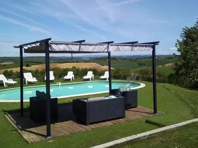 a pool with a gazebo with chairs and a poolurity at Holiday Home für 2 Personen und 2 Kinder by Interhome in Villautou