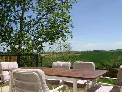 a wooden table and chairs on a deck with a view at Holiday Home für 2 Personen und 2 Kinder by Interhome in Villautou