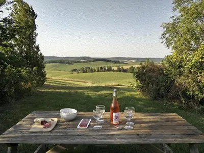 a wooden table with a bottle of wine and glasses at Holiday Home für 2 Personen und 2 Kinder by Interhome in Villautou