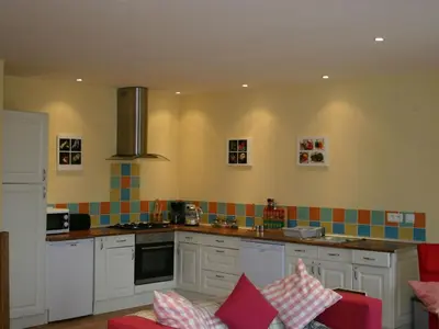 a kitchen with white cabinets and colorful tiles on the wall at Holiday Home für 2 Personen und 2 Kinder by Interhome in Villautou
