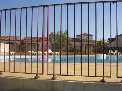 a fence in front of a swimming pool at Holiday Home VILLA T3 PMR ZWISCHEN NARBONNE UND CARCASSONNE by Interhome in Homps