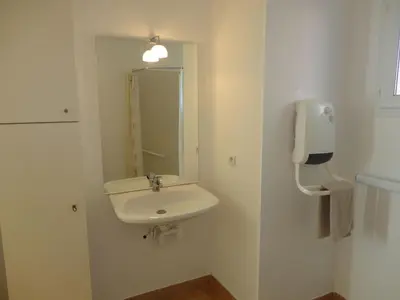 a white bathroom with a sink and a mirror at Holiday Home VILLA T3 PMR ZWISCHEN NARBONNE UND CARCASSONNE by Interhome in Homps