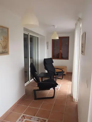 two black chairs sitting in a living room at La Pepiniere a beautiful air-con villa with private pool In the canal-side village of Homps in Homps