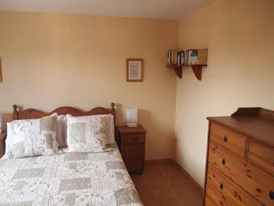 a bedroom with a bed and a wooden dresser at La Pepiniere a beautiful air-con villa with private pool In the canal-side village of Homps in Homps