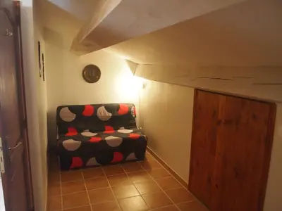 a room with a chair with polka dots at La Pepiniere a beautiful air-con villa with private pool In the canal-side village of Homps in Homps
