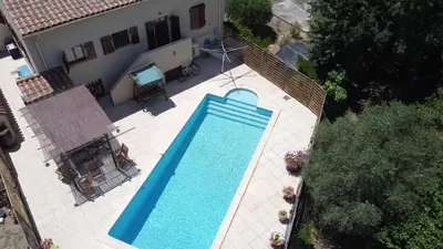 an overhead view of a swimming pool in a house at La Pepiniere a beautiful air-con villa with private pool In the canal-side village of Homps in Homps