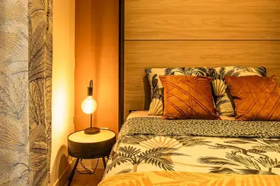 a bedroom with a bed and a lamp on a table at Studio narbonne in Narbonne