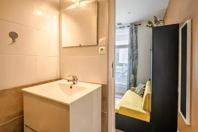 a small bathroom with a sink and a mirror at Studio narbonne in Narbonne